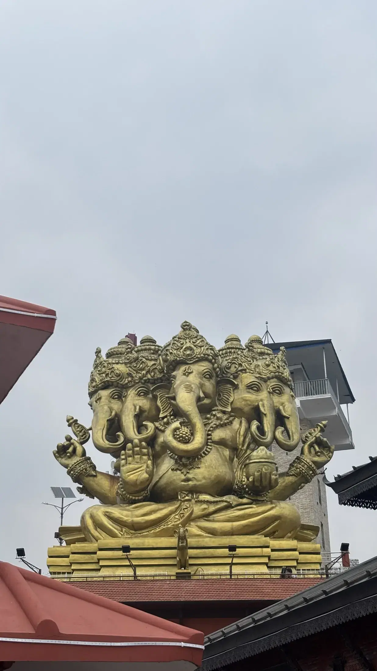 A large golden five-faced Ganesha sculpture at Pumdikot