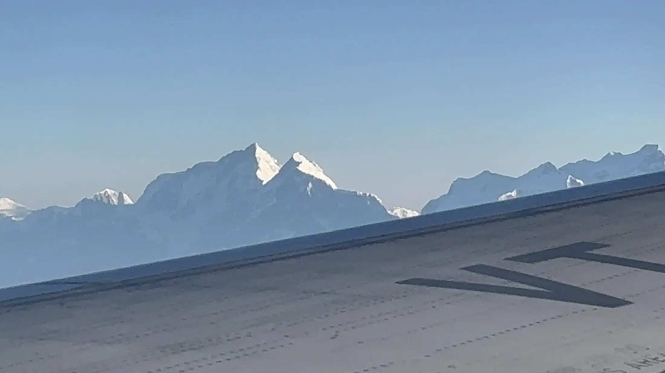 Mount Everest, Lhotse, and Makalu seen From left to right above an aircraft wing