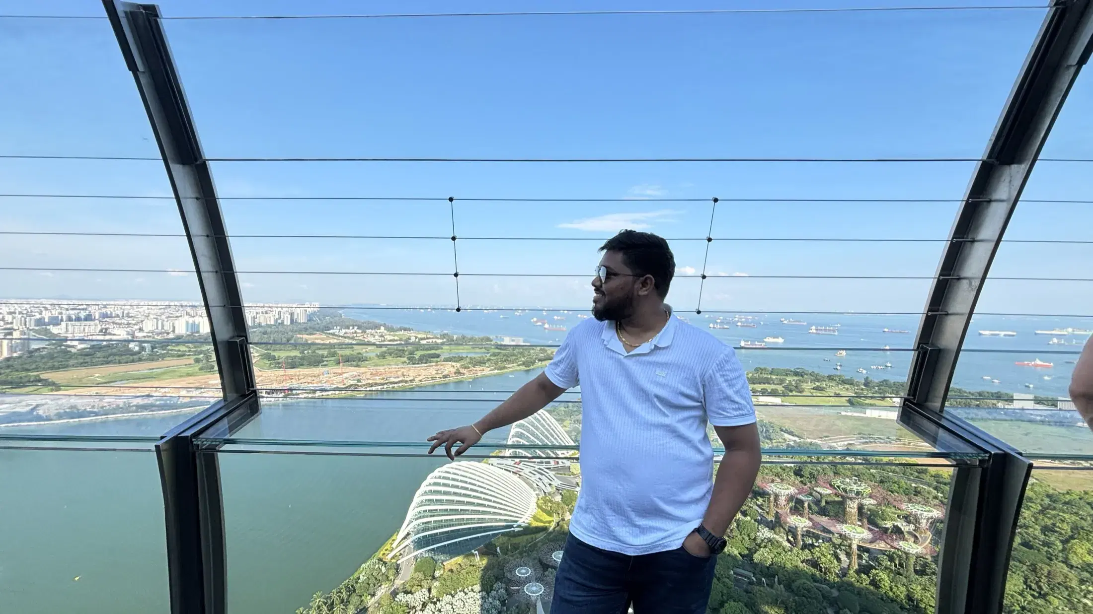 Manish at the Sands SkyPark overlooking Gardens by the Bay and the Singapore Strait
