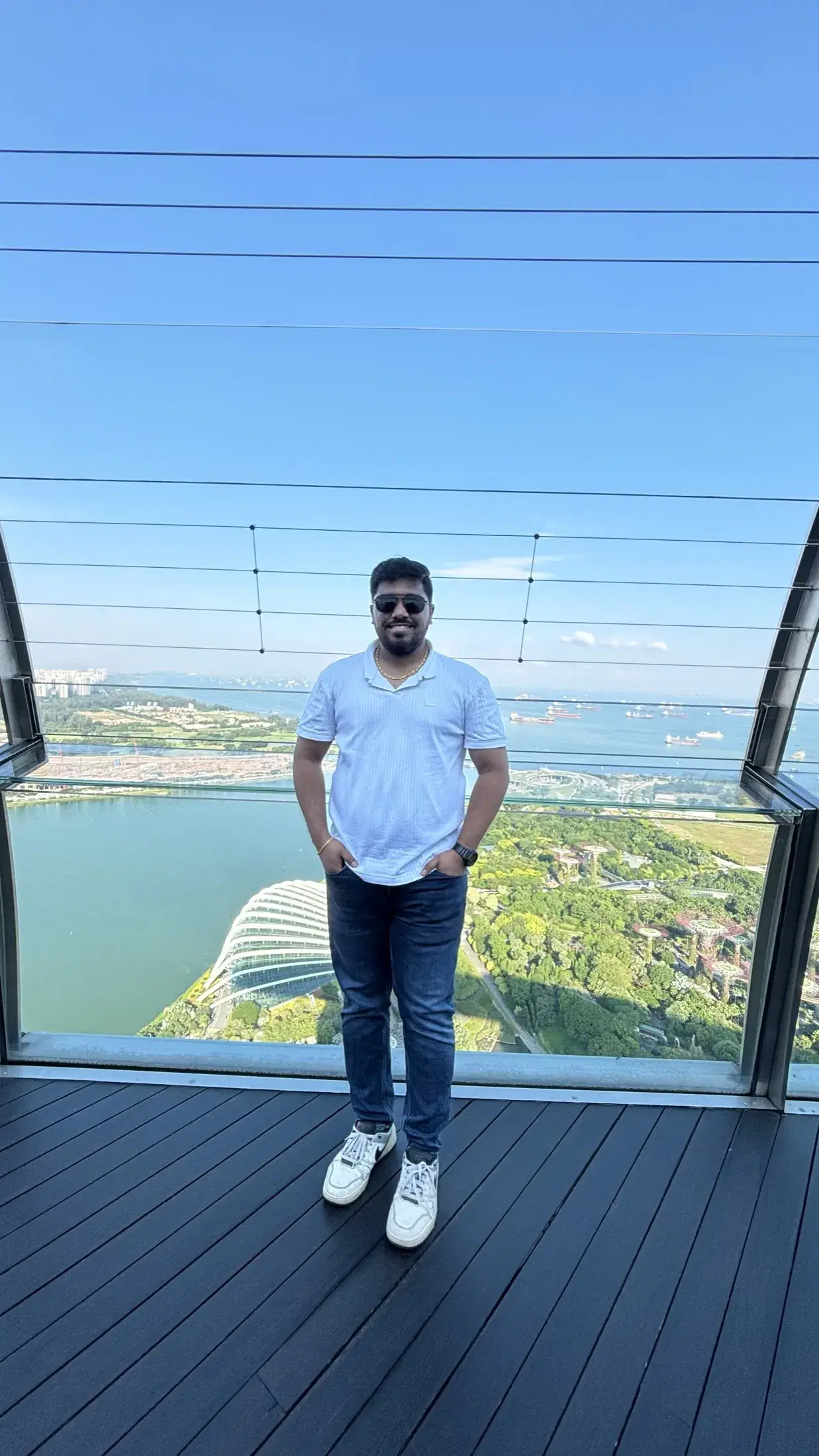Manish at the Sands SkyPark with Gardens by the Bay and anchored ships below