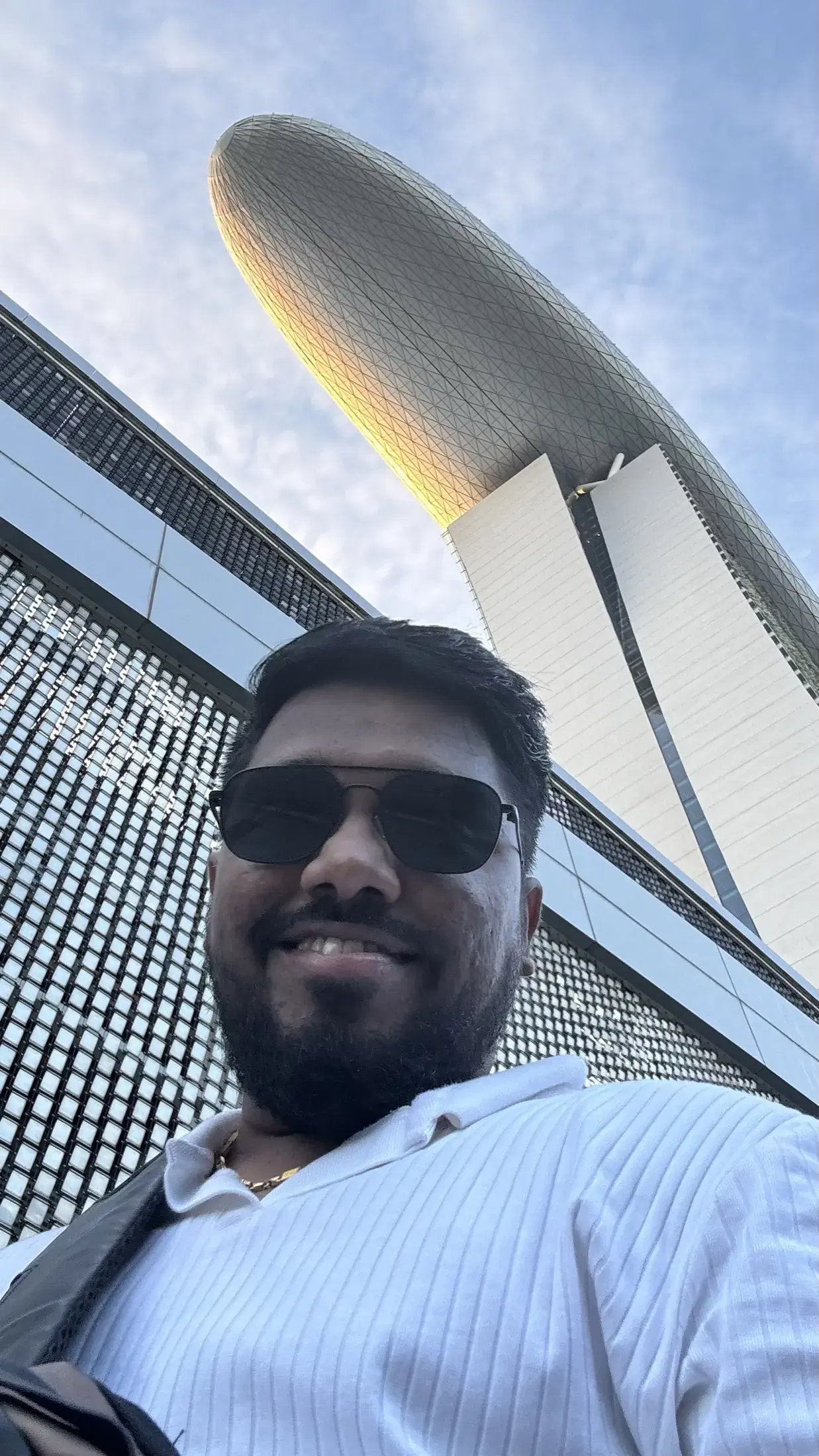 Manish taking a close-up photograph beneath the curved Sands SkyPark roof